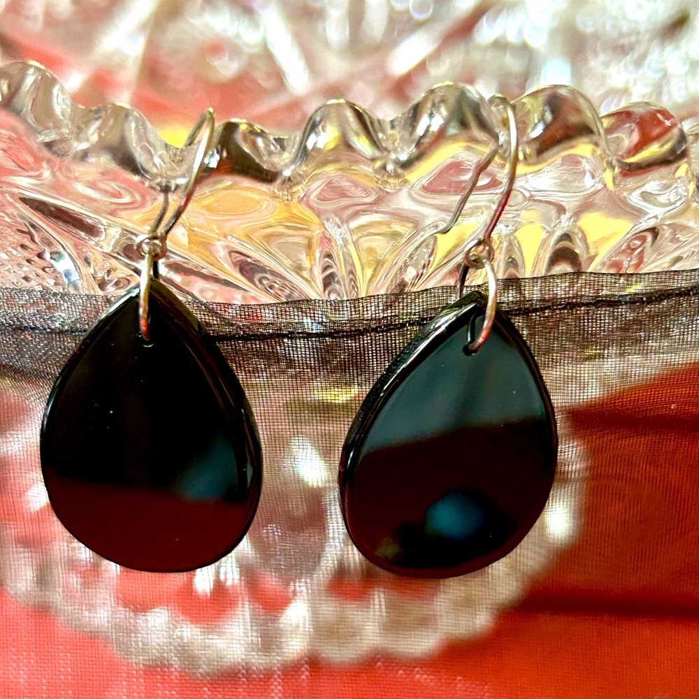 Black plastic teardrop earrings.